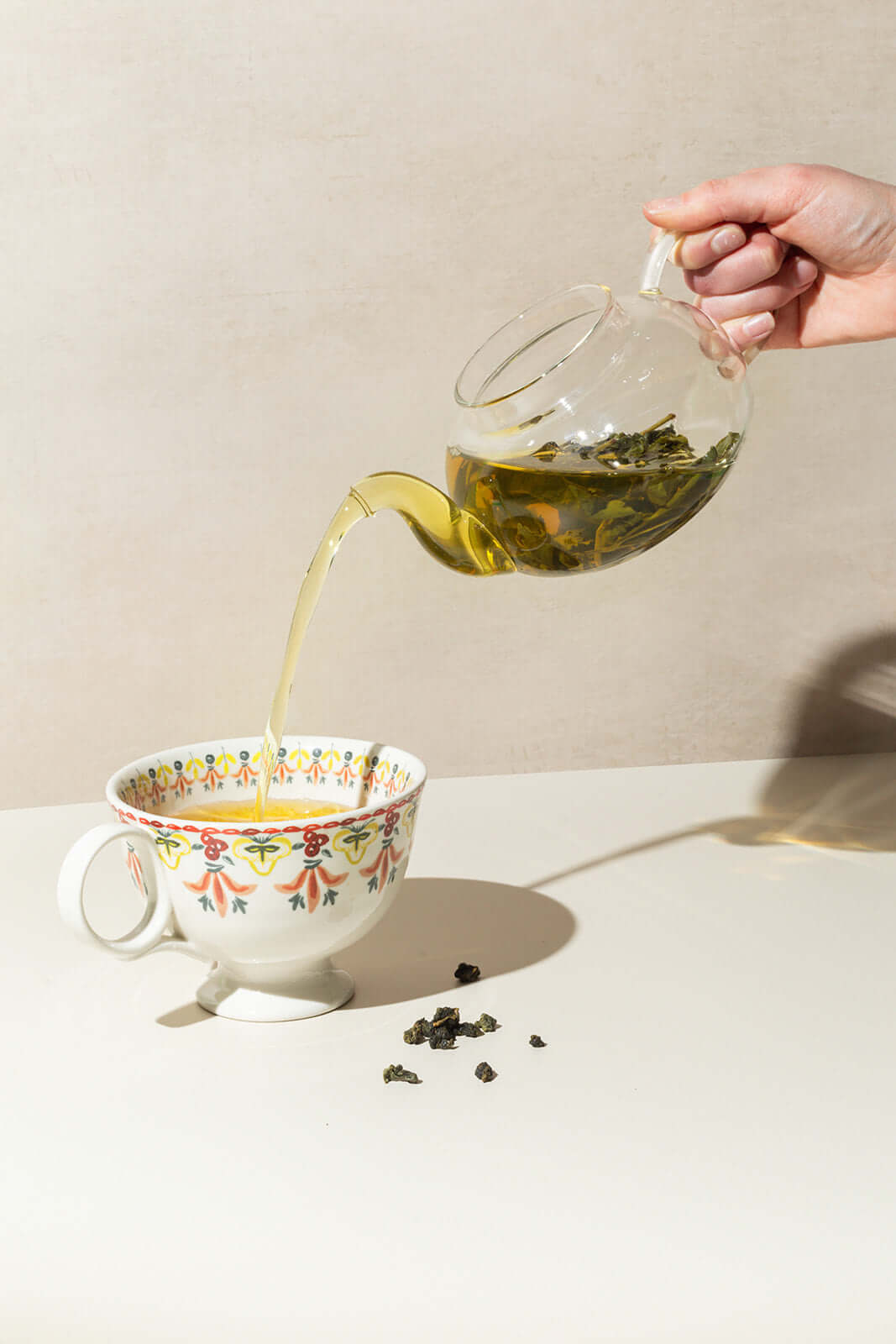 Pouring oolong tea from a teapot